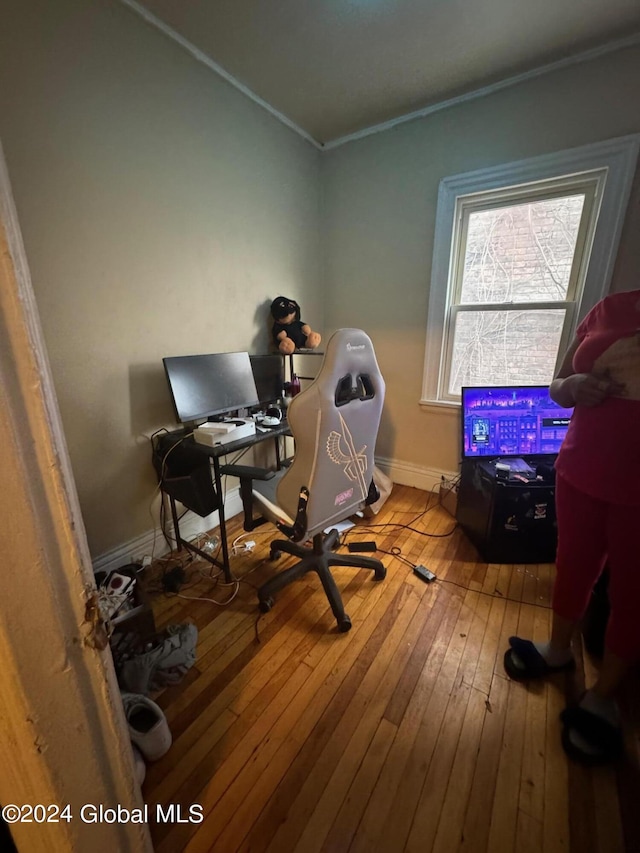 home office with hardwood / wood-style flooring, baseboards, and ornamental molding