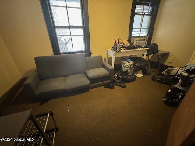 living room with a healthy amount of sunlight, carpet flooring, and cooling unit