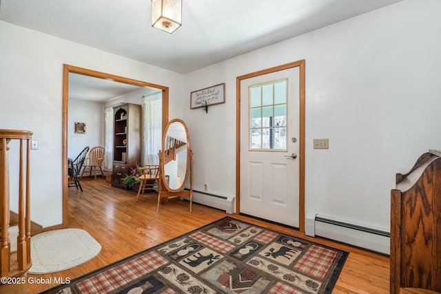 entrance foyer featuring light wood-style floors and a baseboard radiator