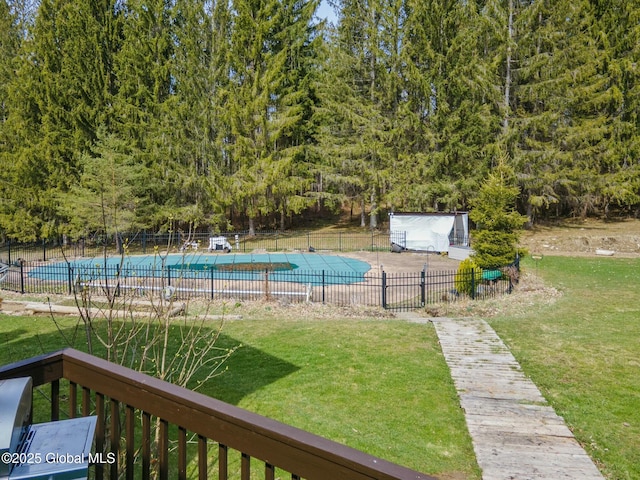 view of yard with a community pool and fence