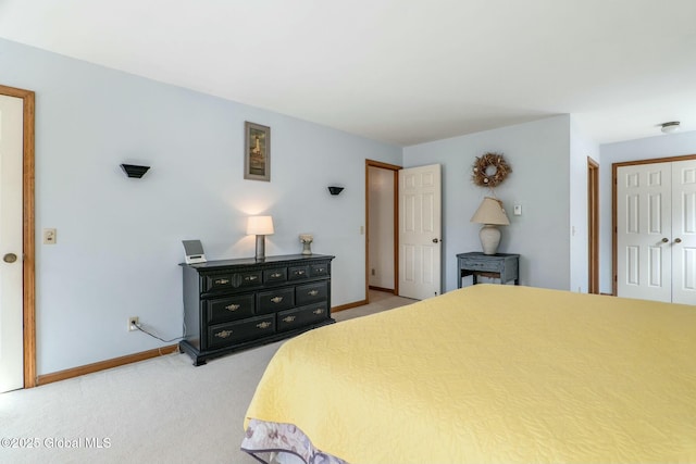 bedroom with light carpet, a closet, and baseboards
