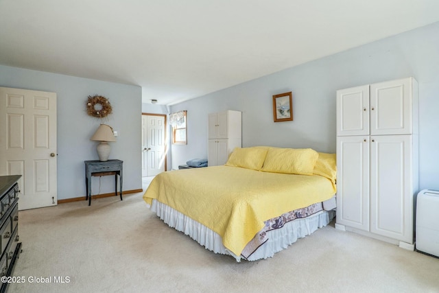 bedroom featuring a closet, baseboards, and light carpet