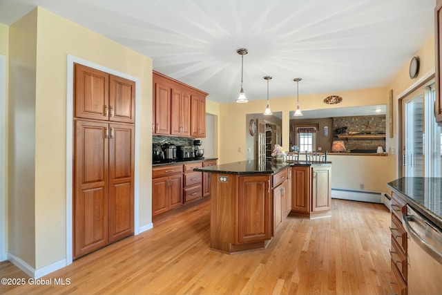 kitchen with light wood finished floors, a center island, backsplash, baseboard heating, and dishwasher