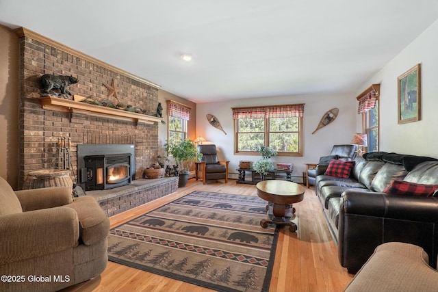 living room with wood finished floors and a brick fireplace