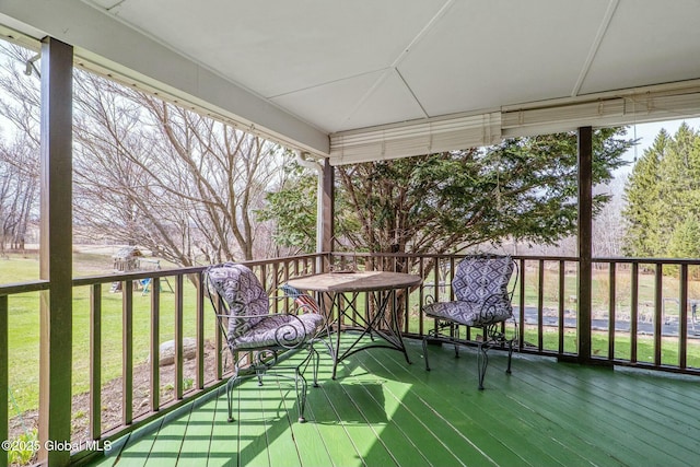 wooden terrace with a yard