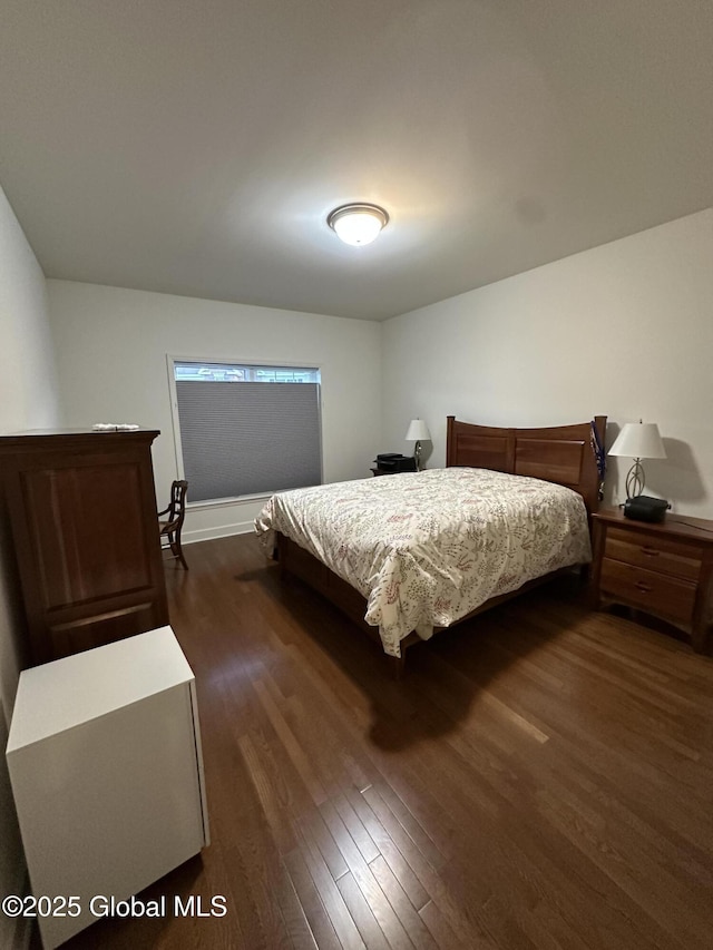 bedroom featuring dark wood-style flooring