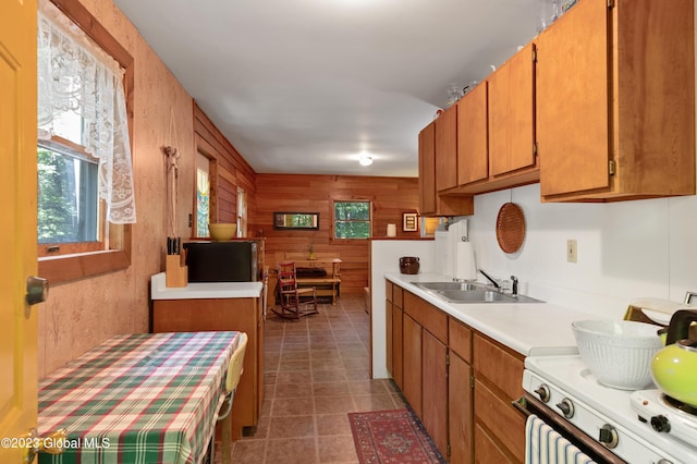 9 E Center St, Day, NY 12835 - kitchen with brown cabinetry, white range oven, a sink, and light countertops