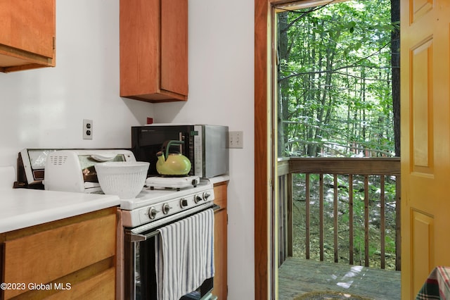 9 E Center St, Day, NY 12835 - kitchen featuring white electric range oven, brown cabinets, and light countertops