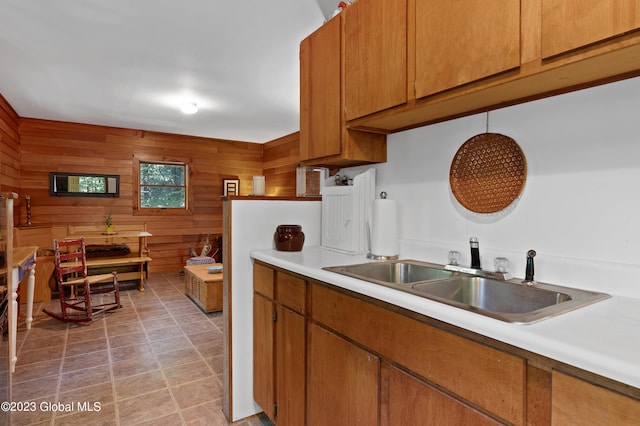 9 E Center St, Day, NY 12835 - kitchen with brown cabinets, a sink, wooden walls, and light countertops