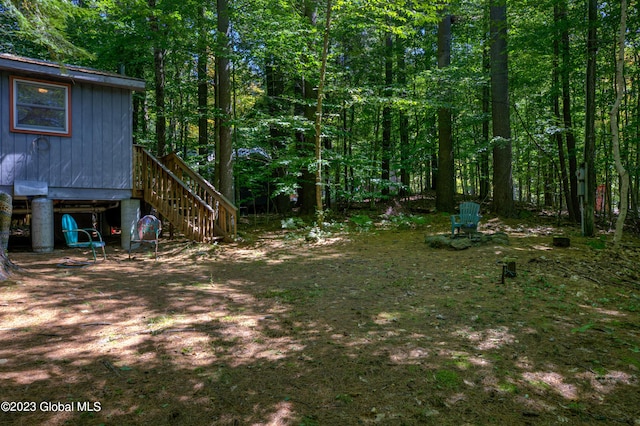 9 E Center St, Day, NY 12835 - view of yard featuring a view of trees and stairway