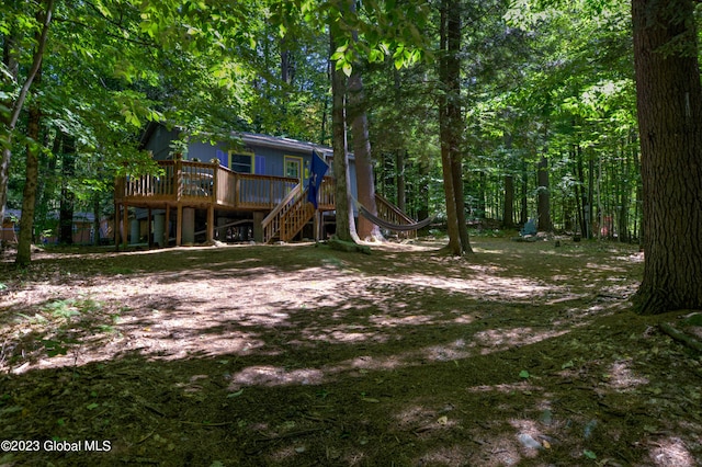 9 E Center St, Day, NY 12835 - view of yard featuring a view of trees, stairs, and a deck