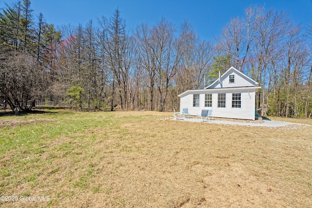view of side of property with a yard
