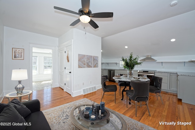 living room with recessed lighting, a ceiling fan, visible vents, and light wood-type flooring