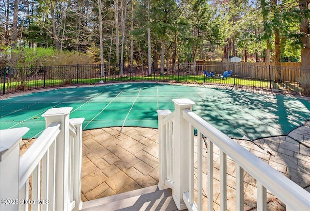 view of pool featuring a fenced in pool, fence, and a patio