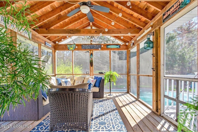 sunroom with ceiling fan and beam ceiling