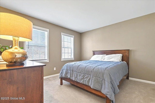 bedroom with baseboards and light colored carpet