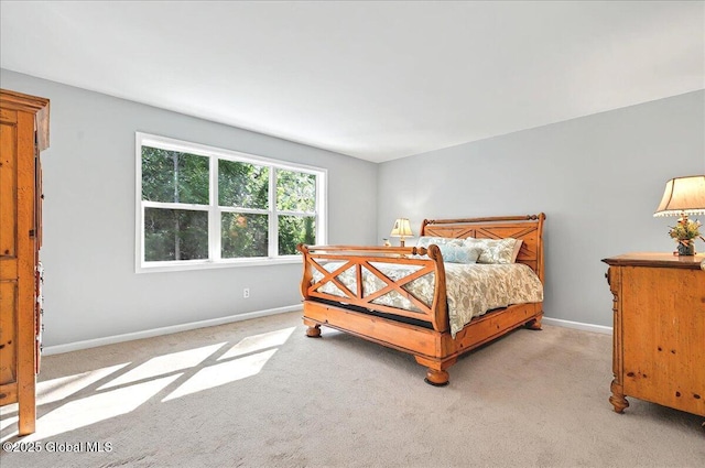 bedroom featuring baseboards and light carpet