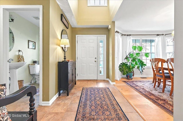 entrance foyer with baseboards and visible vents