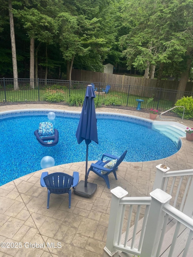 view of pool featuring a fenced in pool, fence, and a patio