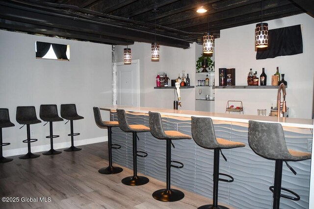 20 Fort Vaux Ln, Colonie, NY 12189 - indoor wet bar featuring wood finished floors, baseboards, and hanging light fixtures