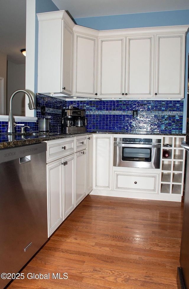20 Fort Vaux Ln, Colonie, NY 12189 - kitchen featuring stainless steel appliances, backsplash, white cabinets, and a sink