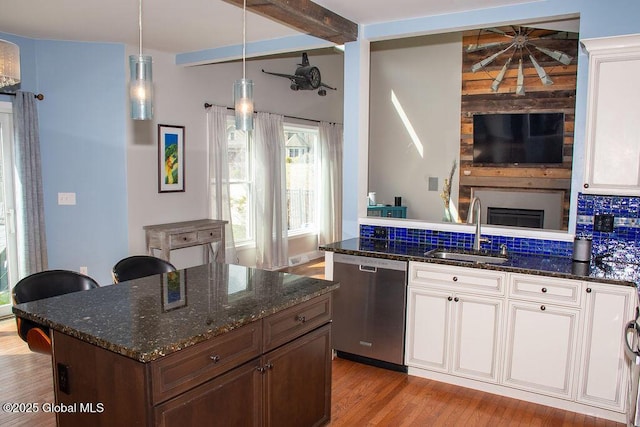 20 Fort Vaux Ln, Colonie, NY 12189 - kitchen with stainless steel dishwasher, a sink, light wood finished floors, dark stone countertops, and beam ceiling