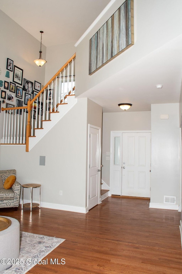 20 Fort Vaux Ln, Colonie, NY 12189 - entryway featuring stairs, wood finished floors, baseboards, and a towering ceiling