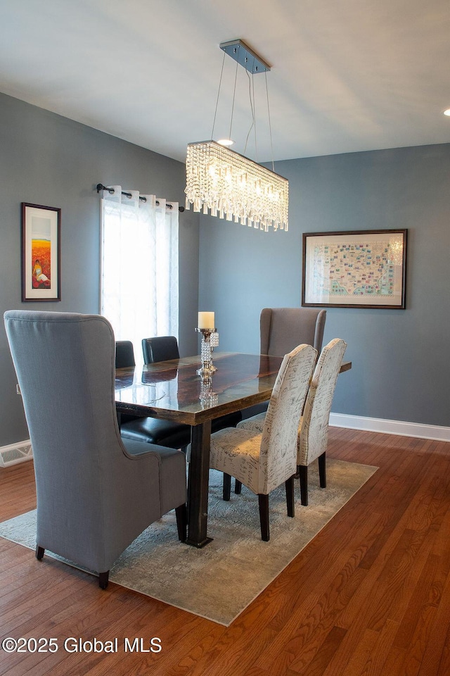 20 Fort Vaux Ln, Colonie, NY 12189 - dining room with baseboards, wood finished floors, and a chandelier