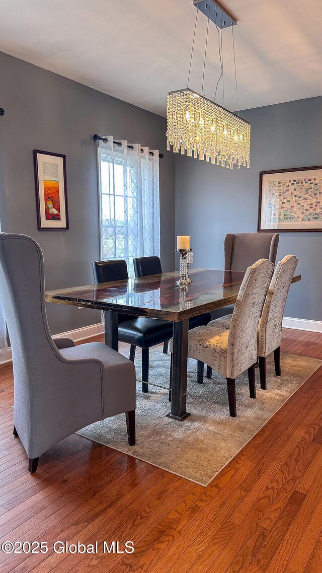 20 Fort Vaux Ln, Colonie, NY 12189 - dining room featuring wood finished floors, a chandelier, and baseboards