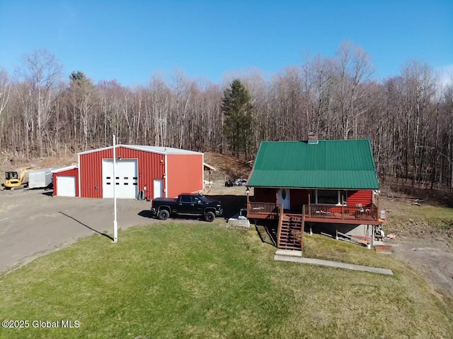 190 Wes Brown Rd, Cherry Valley, NY 13320 - view of front facade featuring a detached garage, a front lawn, an outbuilding, and metal roof