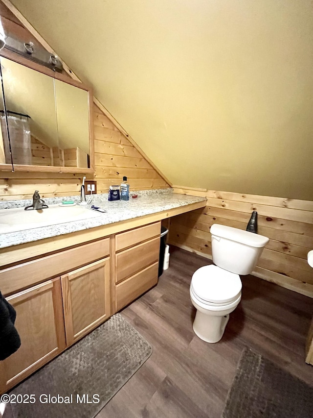 190 Wes Brown Rd, Cherry Valley, NY 13320 - bathroom featuring toilet, wood walls, wood finished floors, vanity, and lofted ceiling