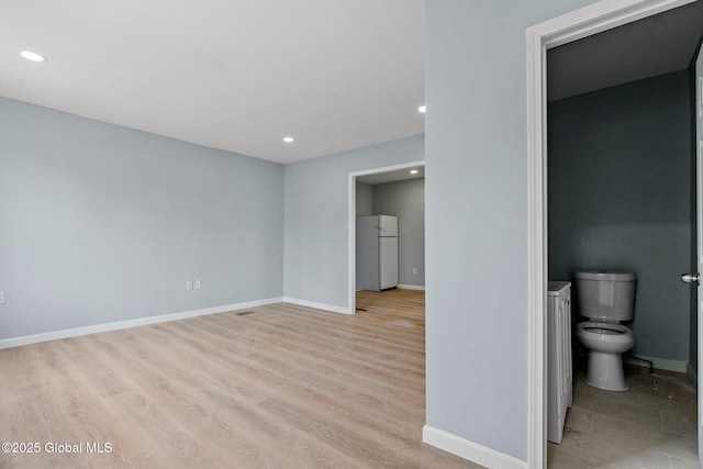 111 Mann Ave, Troy, NY 12180 - interior space with freestanding refrigerator, recessed lighting, baseboards, ensuite bathroom, and light wood-type flooring