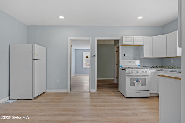 111 Mann Ave, Troy, NY 12180 - kitchen featuring white appliances, white cabinetry, baseboards, and light countertops