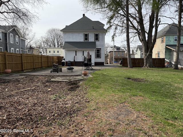 rear view of house with a residential view, a patio area, and fence