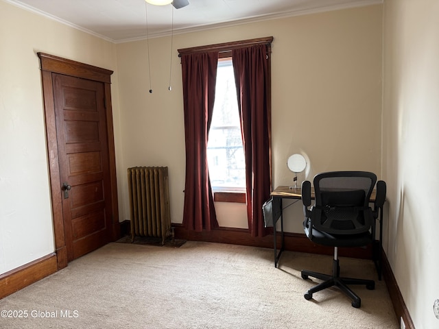 carpeted home office featuring ceiling fan, baseboards, radiator heating unit, and crown molding