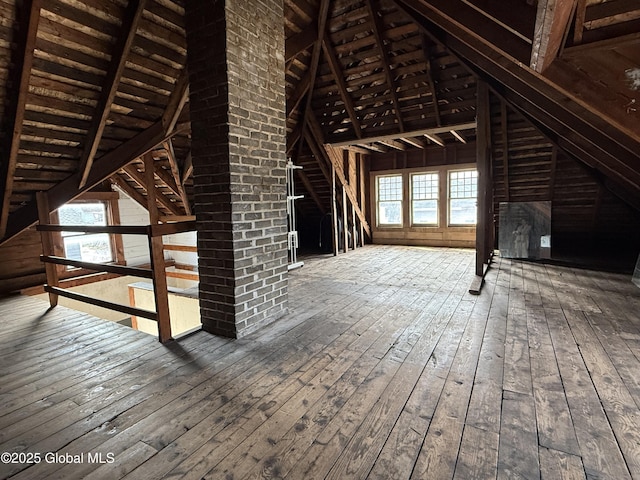 unfinished attic with a wealth of natural light and an upstairs landing