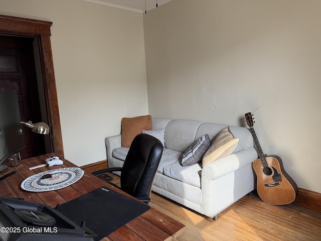 office featuring baseboards, crown molding, and wood finished floors