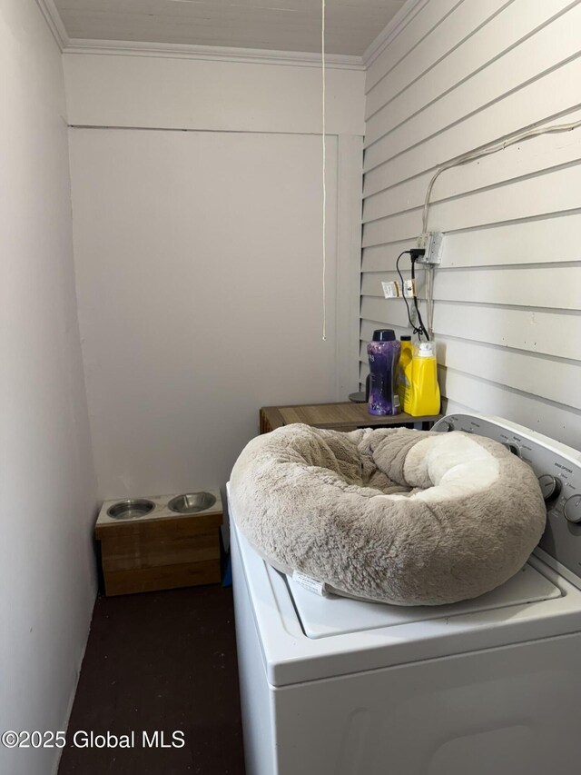 laundry room with washer / dryer, wooden walls, and crown molding