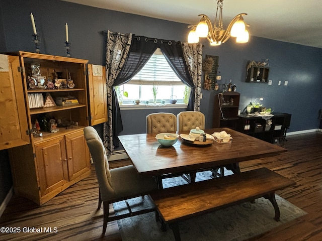 dining room with dark wood-style flooring, baseboards, and a notable chandelier