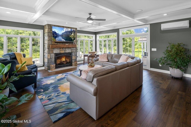 living room with baseboards, coffered ceiling, a wall mounted AC, and a healthy amount of sunlight