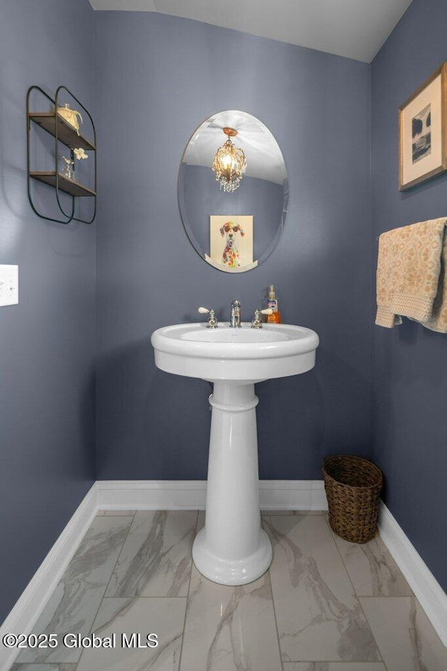 bathroom with baseboards and marble finish floor