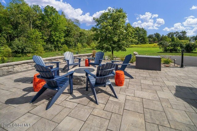 view of patio / terrace featuring an outdoor fire pit