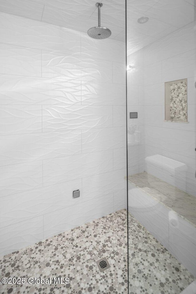 bathroom with a tile shower