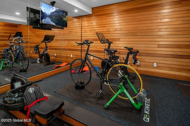 exercise area with wooden walls and recessed lighting