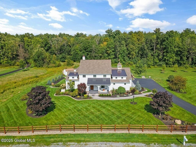 drone / aerial view featuring a wooded view