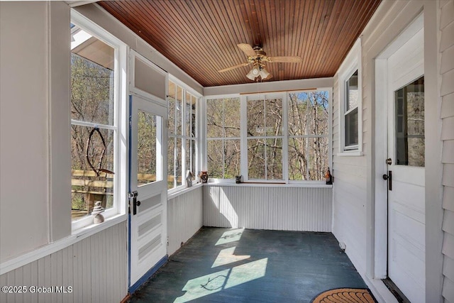 unfurnished sunroom featuring a ceiling fan