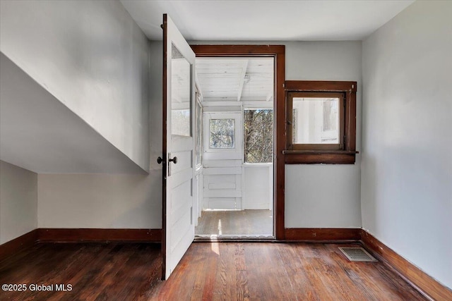 entryway featuring baseboards, wood finished floors, and visible vents
