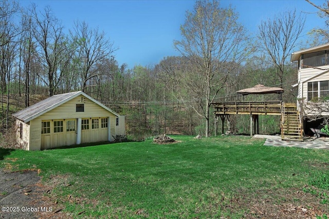 view of yard with a gazebo, an outdoor structure, and stairs