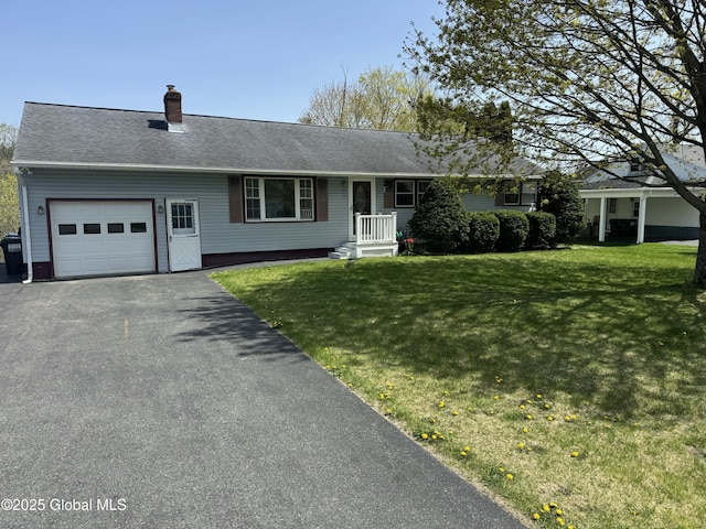 ranch-style home featuring an attached garage, a chimney, driveway, and a front yard