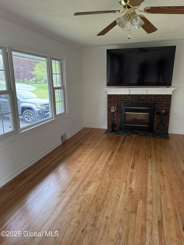 19 Callaghan Blvd, Charlton, NY 12019 - unfurnished living room featuring crown molding, a fireplace, wood finished floors, ceiling fan, and baseboards
